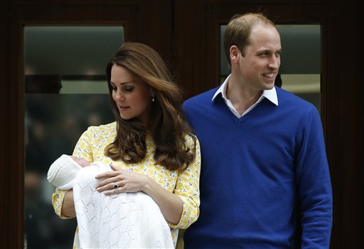 Britain's Prince William, right, and Kate, Duchess of Cambridge, pose for the media with their newborn daughter outside St. Mary's Hospital's exclusive Lindo Wing, London, Saturday, May 2, 2015. The Duchess gave birth to the Princess on Saturday morning. (AP Photo/Alastair Grant)