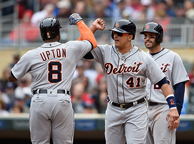 MINNEAPOLIS, MN - APRIL 30: Victor Martinez #41 and J.D. Martinez #28 of the Detroit Tigers congratulate teammate Justin Upton #8 on a three-run home run against the Minnesota Twins during the first inning of the game on April 30, 2016 at Target Field in Minneapolis, Minnesota.   Hannah Foslien/Getty Images/AFP