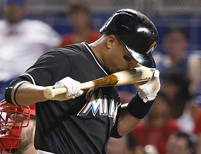 Miami Marlins' Martin Prado reacts between pitches as he bats during the sixth inning of a baseball game against the Philadelphia Phillies, Tuesday, July 26, 2016, in Miami. Prado doubled during the at-bat. The Marlins defeated the Phillies 5-0. (AP Photo/Wilfredo Lee)