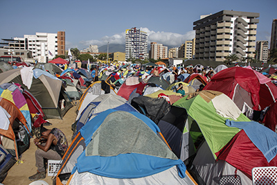 Young supporters of the government of Venezuela's President Nicolas Maduro camp in the vicinity of the convention center where the Non-Aligned Movement summit is taking place, in Porlamar, Margarita Island, Venezuela, on September 16, 2016. Left increasingly isolated by a crushing political and economic crisis, Venezuela will seek the support of old friends when it hosts a summit of the Non-Aligned Movement this weekend. / AFP PHOTO / Gustavo Granados