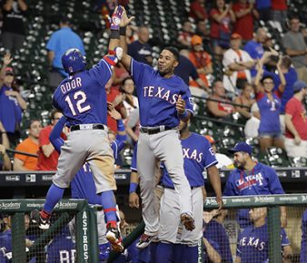 Texas Rangers' Rougned Odor (12) celebrates with Elvis Andrus, right, after hitting a home run against the Houston Astros during the 12th inning of a baseball game Monday, Sept. 12, 2016, in Houston. (AP Photo/David J. Phillip)
