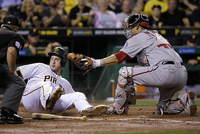 Pittsburgh Pirates' David Freese, left, scores as the ball gets away from Washington Nationals catcher Wilson Ramos in the second inning of a baseball game in Pittsburgh, Friday, Sept. 23, 2016. Freese scored from second on a single by Adam Frazier. (AP Photo/Gene J. Puskar)