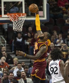 Cleveland Cavaliers' LeBron James makes a basket as Toronto Raptors' Lucas Nogueira (92) watches during the first half of an NBA basketball game in Cleveland, Tuesday, Nov. 15, 2016. (AP Photo/Phil Long)