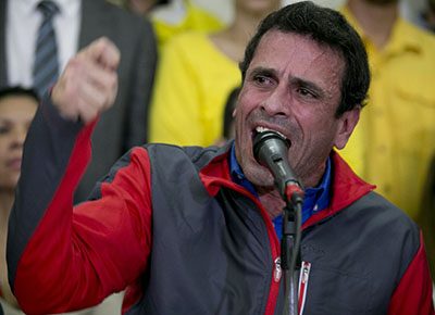 Opposition leader Henrique Capriles speaks during a press conference, in Caracas, Venezuela, Friday, Oct. 21, 2016. Venezuela's electoral authority suspended a recall drive against President Nicolas Maduro on Thursday, less than a week before it was set to start, throwing the opposition's key campaign to oust the leader into further disarray. In a related move, a court appeared to issue a ruling Friday blocking key opposition leaders, including Capriles, from leaving the country. (AP Photo/Ariana Cubillos)