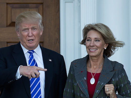 BEDMINSTER TOWNSHIP, NJ - NOVEMBER 19: (L to R) president-elect Donald Trump and Betsy DeVos pose for a photo after their meeting at Trump International Golf Club, November 19, 2016 in Bedminster Township, New Jersey. Trump and his transition team are in the process of filling cabinet and other high level positions for the new administration.   Drew Angerer/Getty Images/AFP