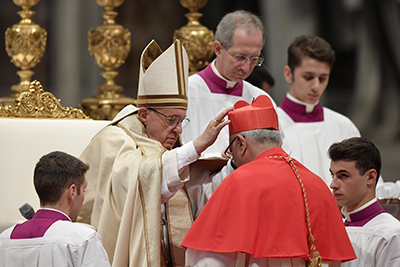 Archbishop of Merida in Venezuela, Baltazar Enrique Porras Cardozo, kneels before Pope Francis to pledge allegiance and become cardinal, on November 19, 2016 during a consistory at Peter's basilica. Pope Francis has named 17 new cardinals, 13 of them under age 80 and thus eligible to vote in a conclave to elect his successor. / AFP PHOTO / TIZIANA FABI
