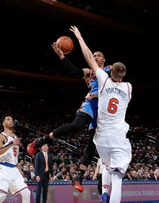 NEW YORK CITY - NOVEMBER 28: Russell Westbrook #0 of the Oklahoma City Thunder shoots against Kristaps Porzingis #6 of the New York Knicks during a game between the Oklahoma City Thunder and the New York Knicks at Madison Square Garden in New York, New York. NOTE TO USER: User expressly acknowledges and agrees that, by downloading and/or using this Photograph, user is consenting to the terms and conditions of the Getty Images License Agreement. Mandatory Copyright Notice: Copyright 2016 NBAE   Nathaniel S. Butler/NBAE via Getty Images/AFP
