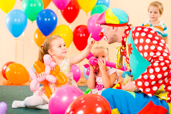 happy children and clown on birthday party